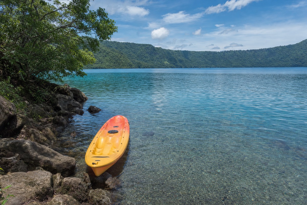 Kayakers on the clear water of the Laguna de Apoyo crater lake near Granada