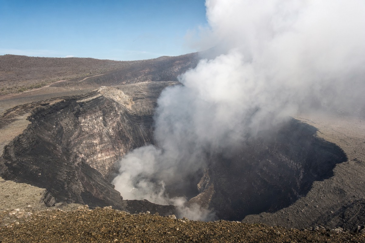 Orange lava glow rising from the active Santiago Crater at Masaya Volcano after dark