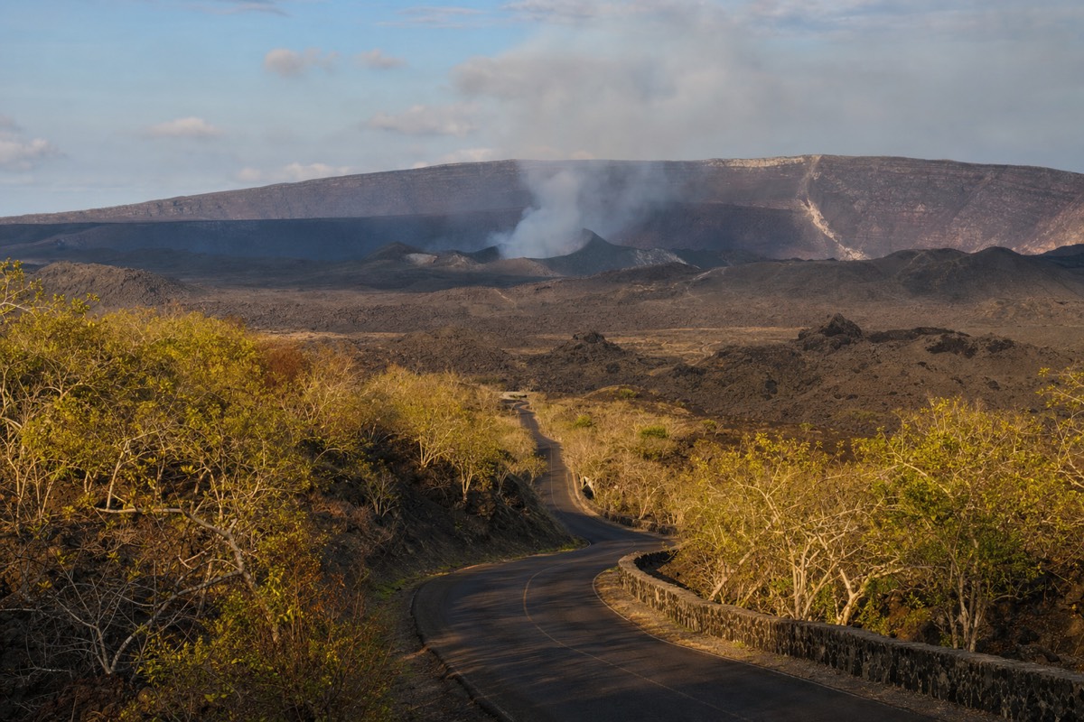 The road up to Masaya Volcano National Park with the smoking crater in the distance