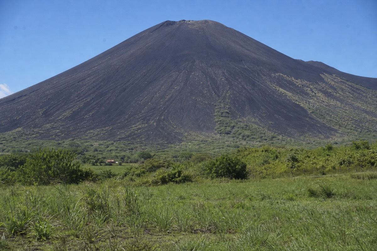 Volcano boarding down the black ash slope of Cerro Negro