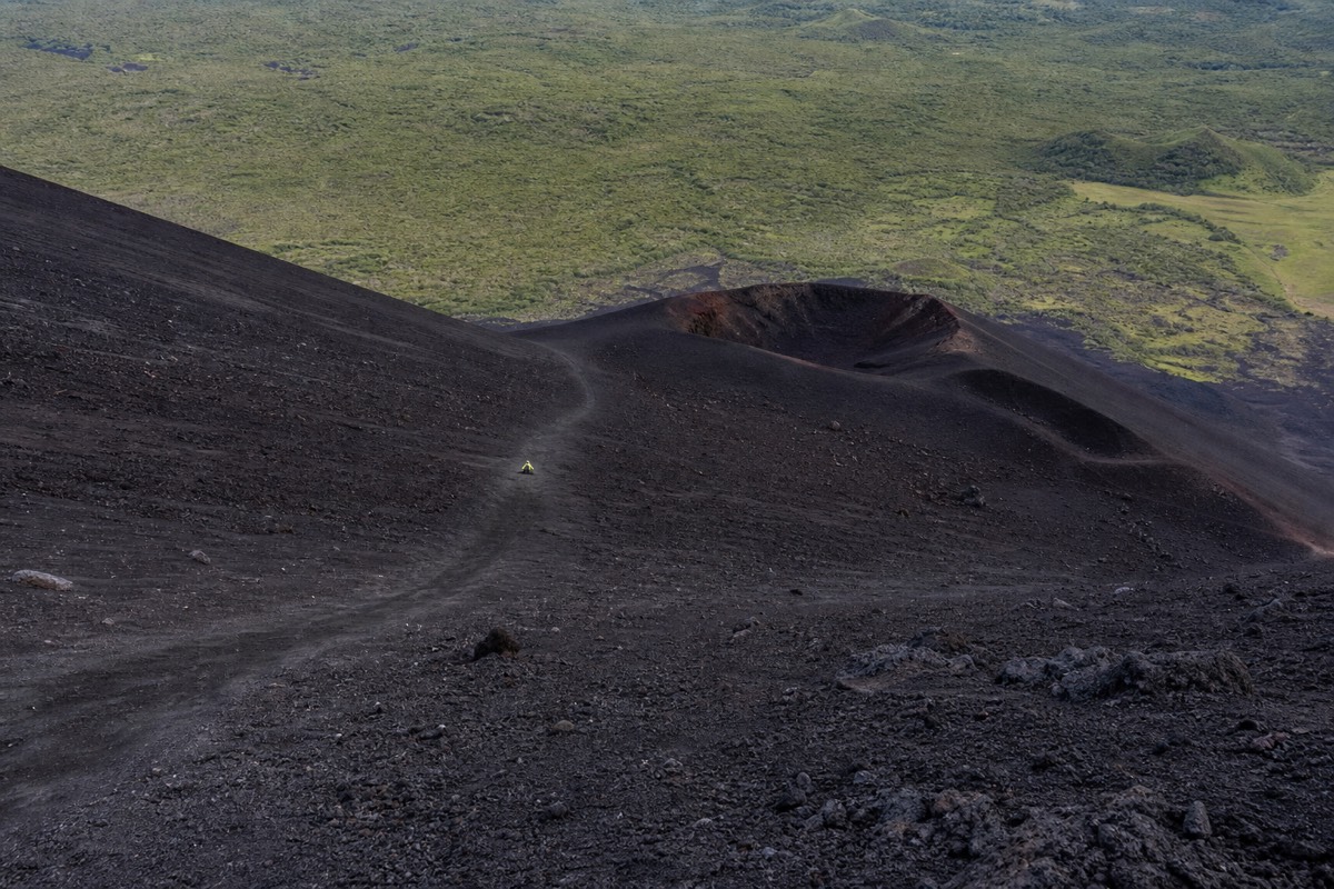 Volcano boarding down the black ash slope of Cerro Negro